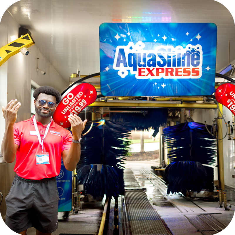 AquaShine Express Car Wash team member welcoming customers at the entrance to the wash tunnel