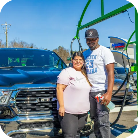 AquaShine Express Car Wash happy couple in front of truck using the wash supplies after going through the express tunnel